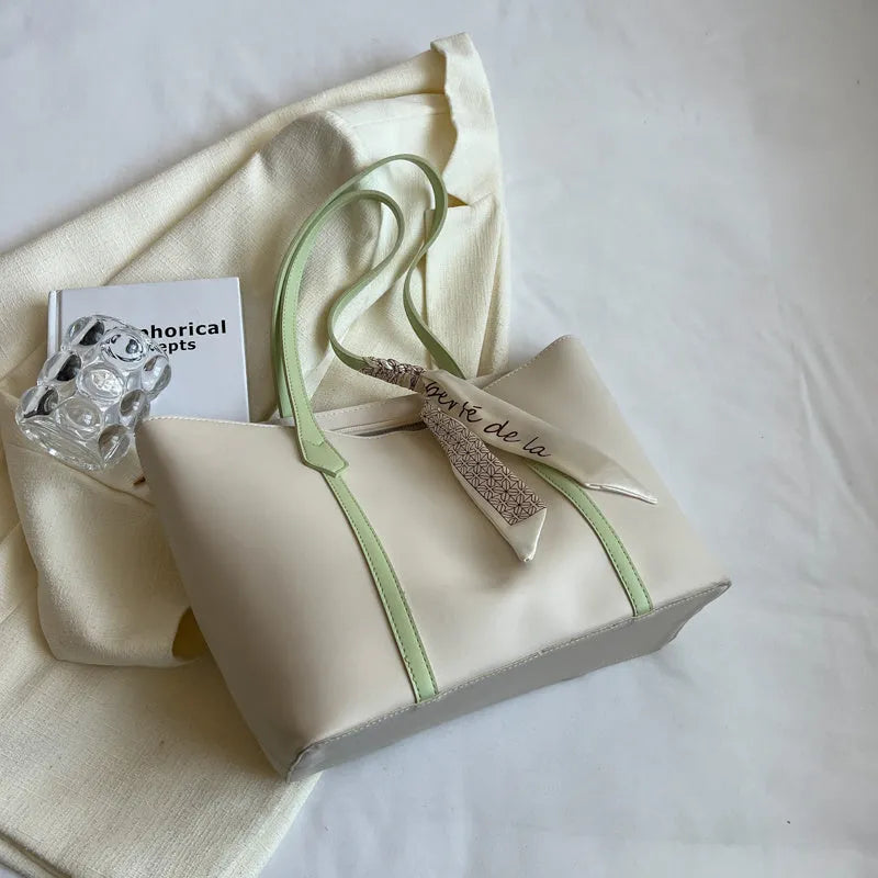 Soft large capacity tote bag with crossbody strap in khaki colour showing outer pocket and sewing line detail