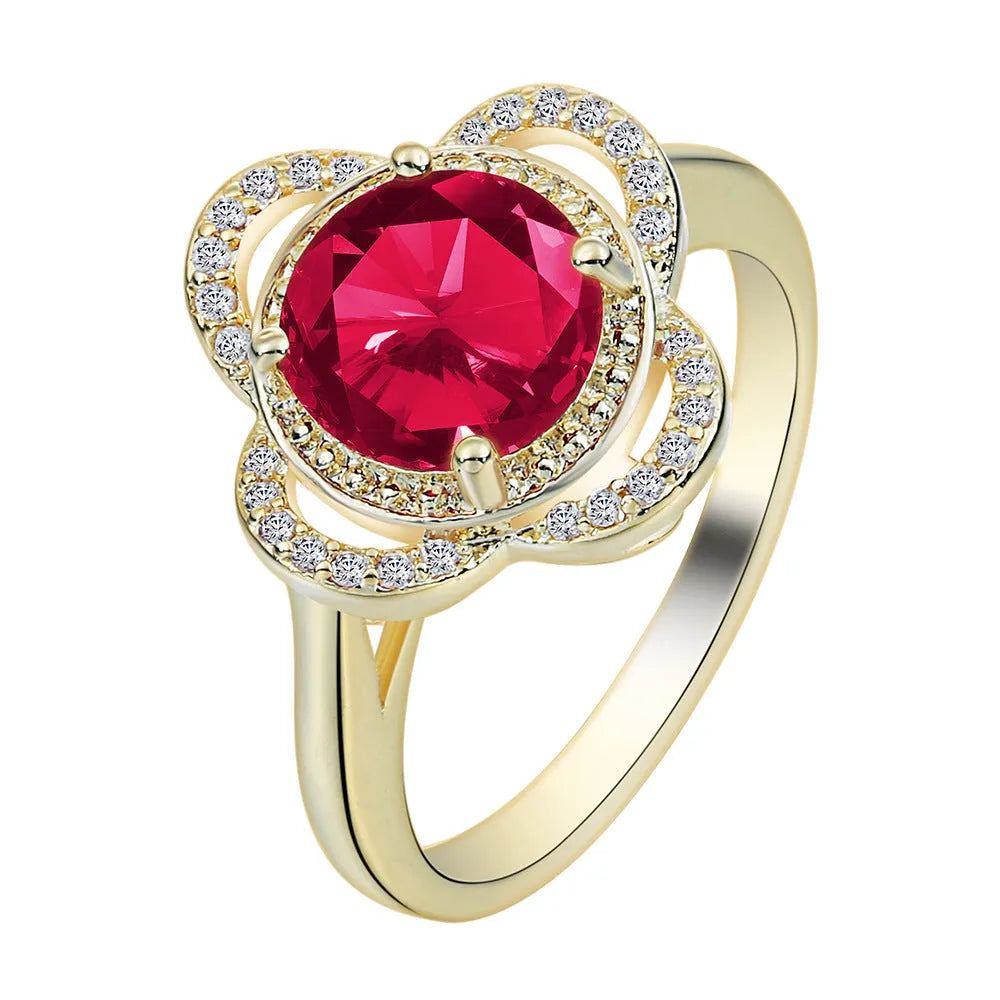 Copper fruit-shaped ring with electroplated zircon detailing on a hand.