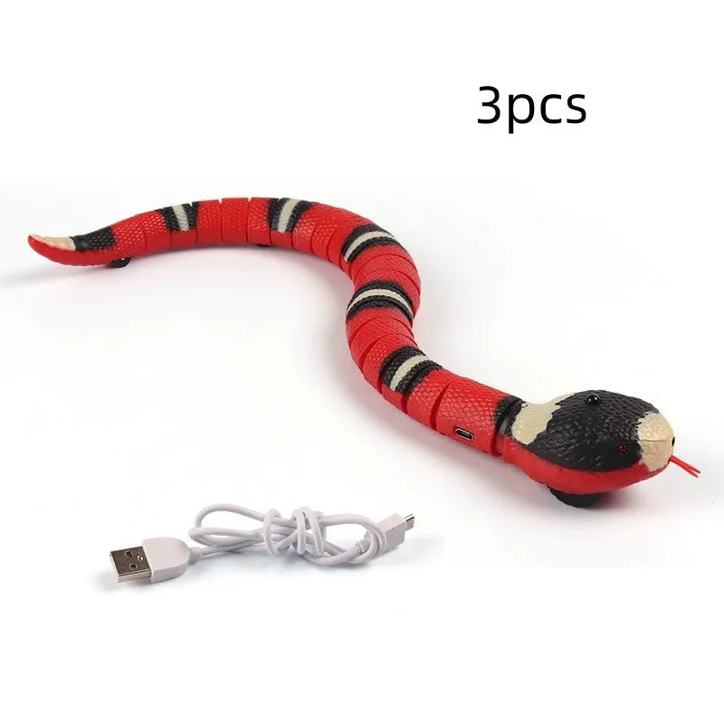 Automatic electronic snake cat toy with segmented plastic body on a floor.