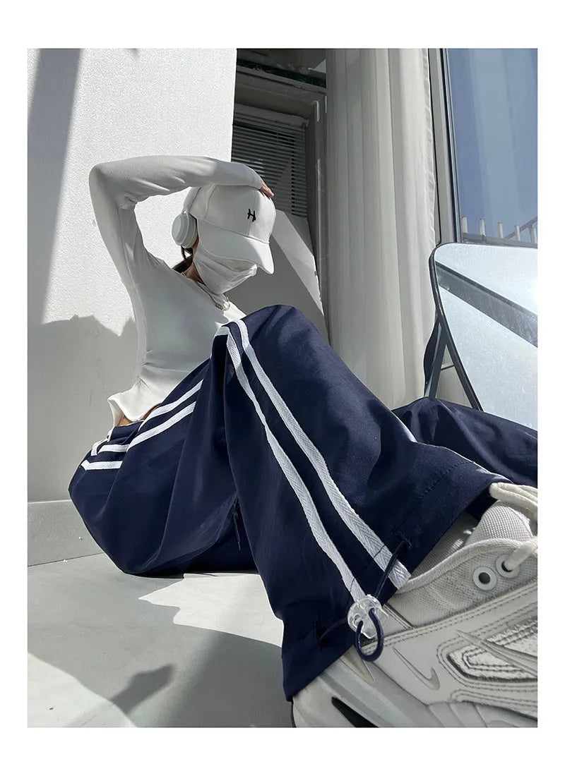 Women's navy blue loose straight trousers with white ribbon parallel bar waistband detail