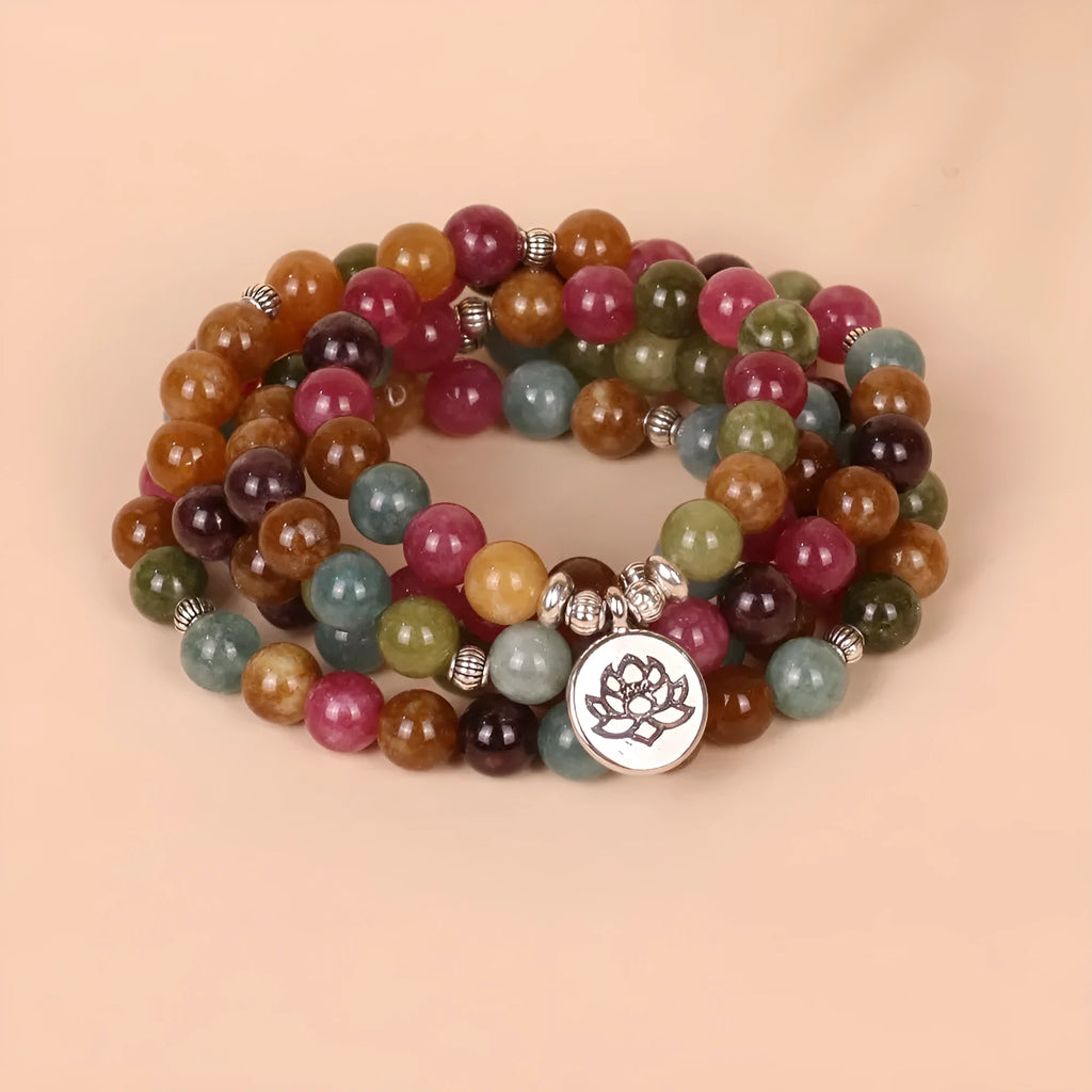 108 bead multi-layer bracelet with lotus pendant in Tourmaline colour and alloy construction.