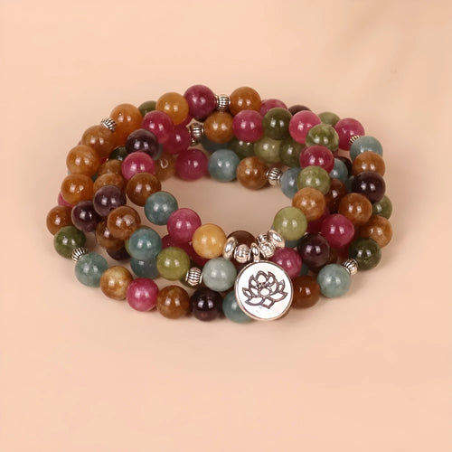 108 bead multi-layer bracelet with lotus pendant in Tourmaline colour and alloy construction.