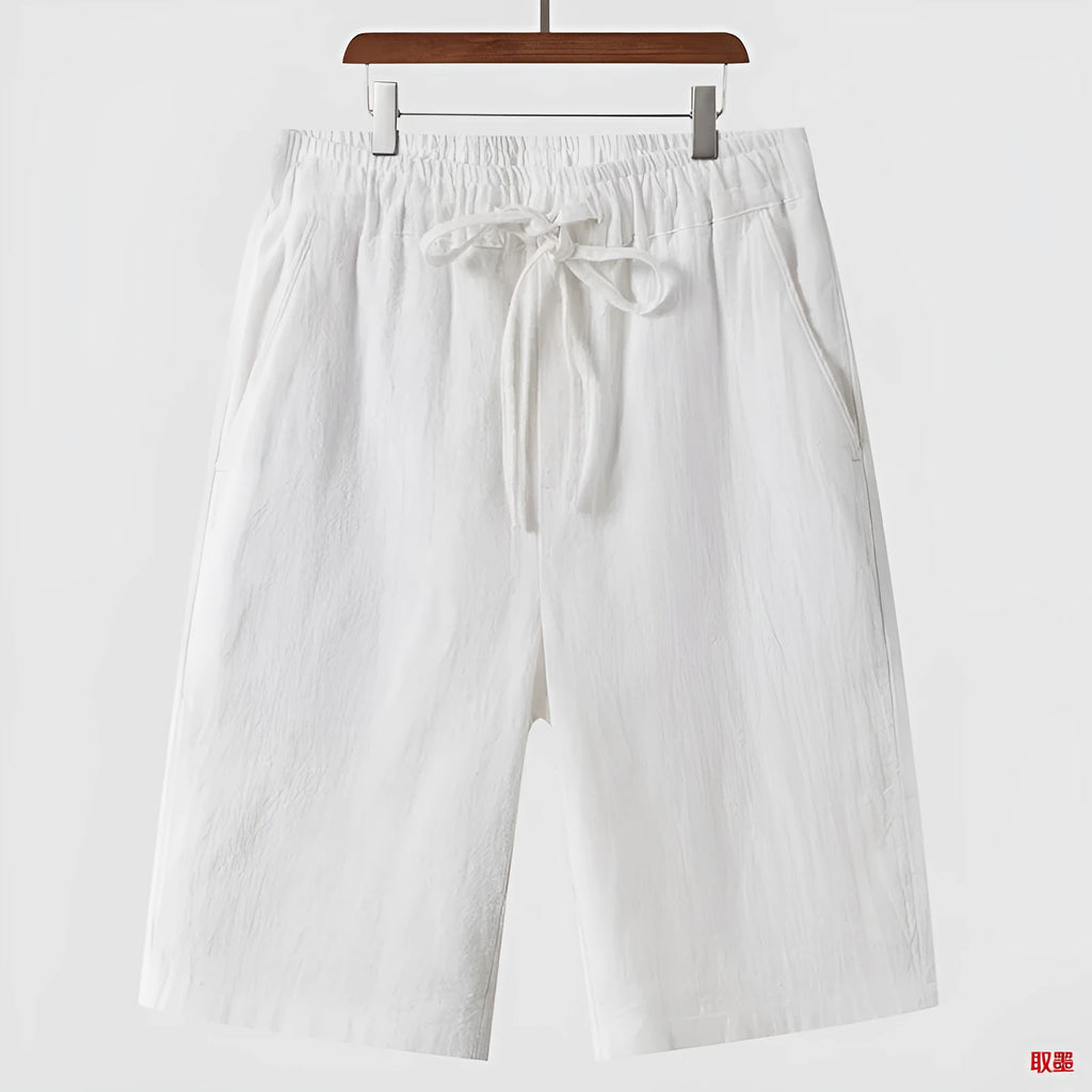 Men's linen shorts in loose cropped design with elastic waistband, shown in available colours