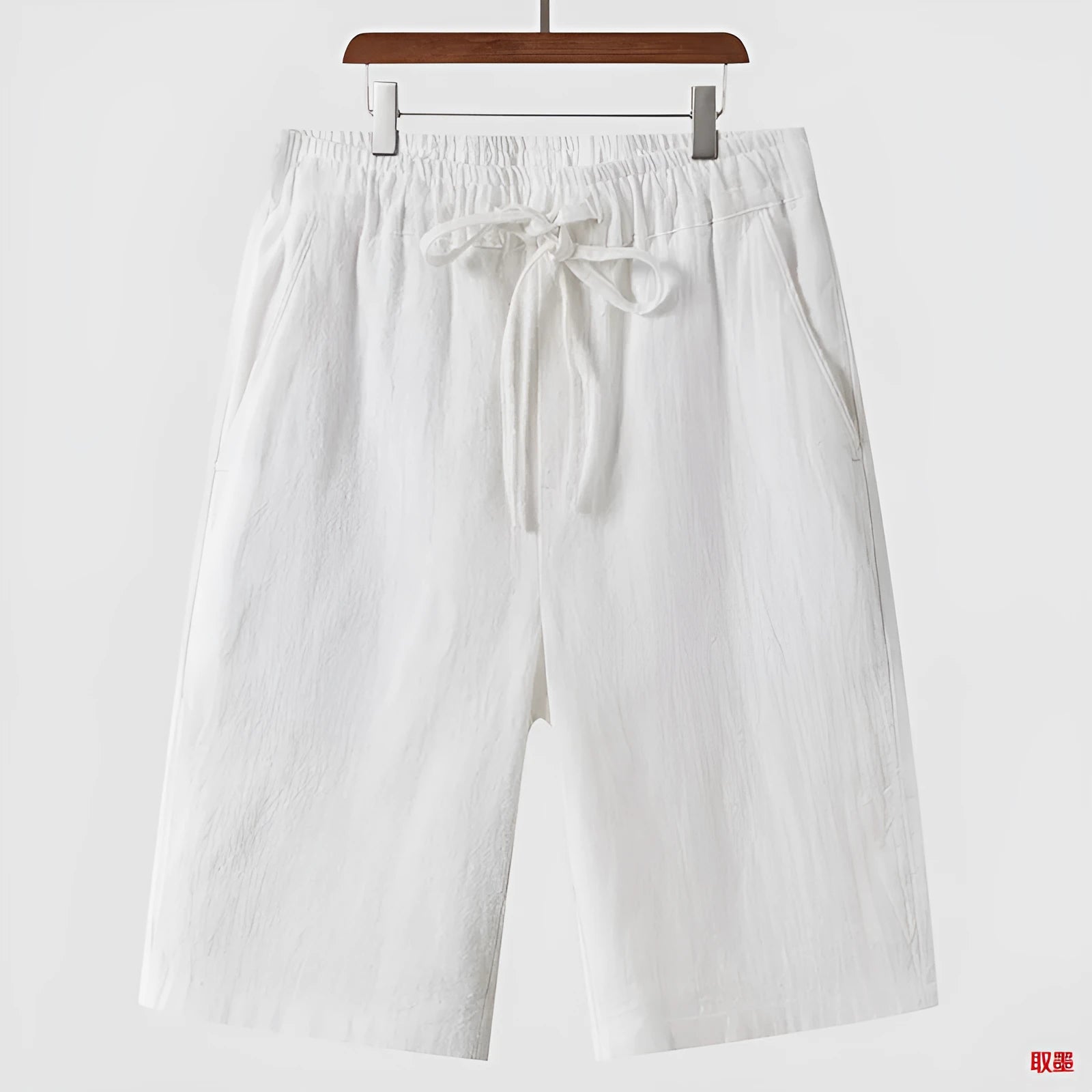 Men's linen shorts in loose cropped design with elastic waistband, shown in available colours