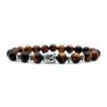 Handcrafted unisex bracelet with a 19mm Buddha head bead in tiger eye stone on wrist.