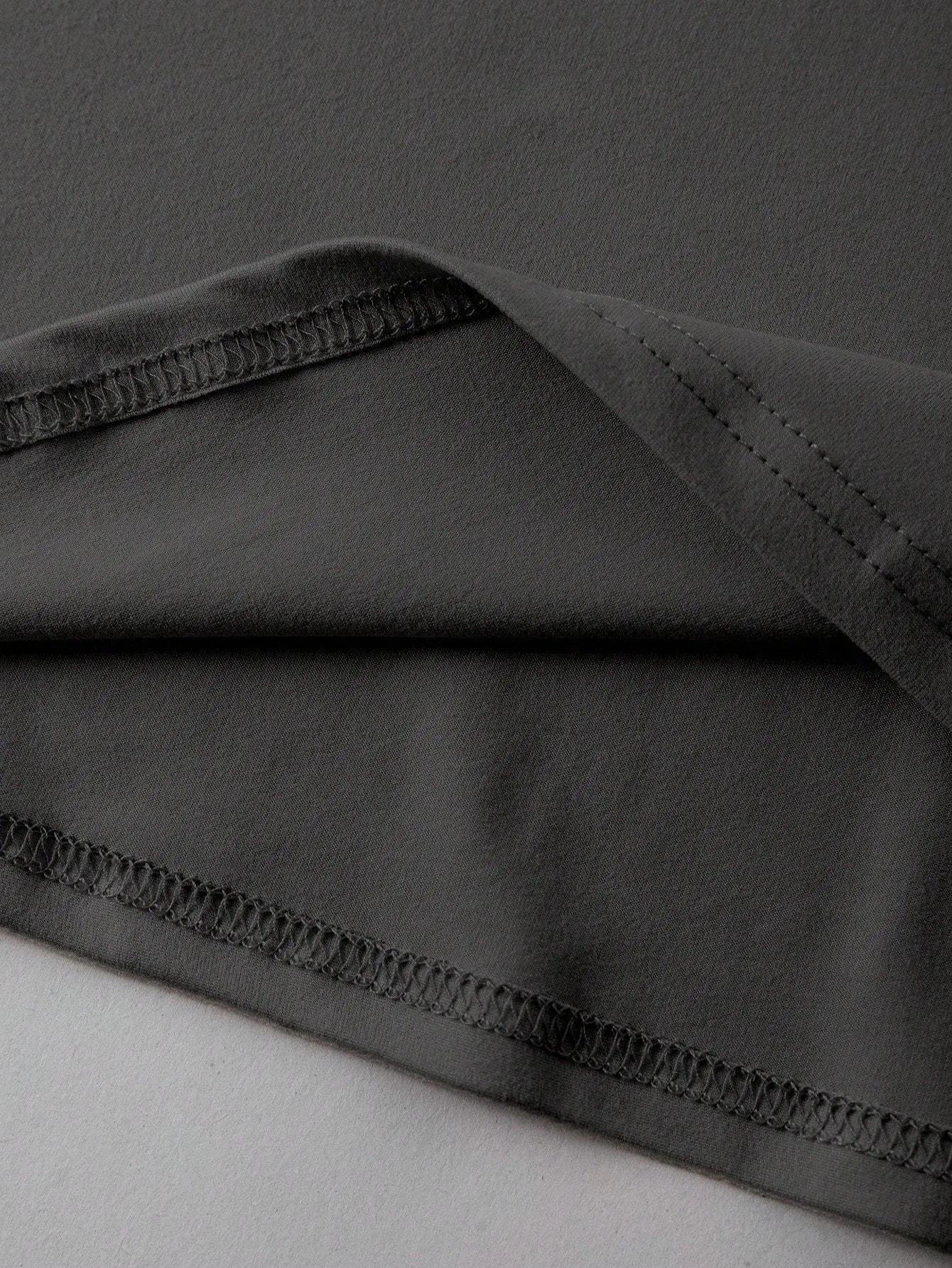 Loose fit cotton short sleeve T-shirt in black, green, grey, or orange on a hanger