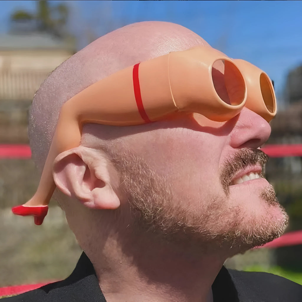 Orange plastic Personality Leg Hip Sunglasses showing novelty leg and hip motif design.