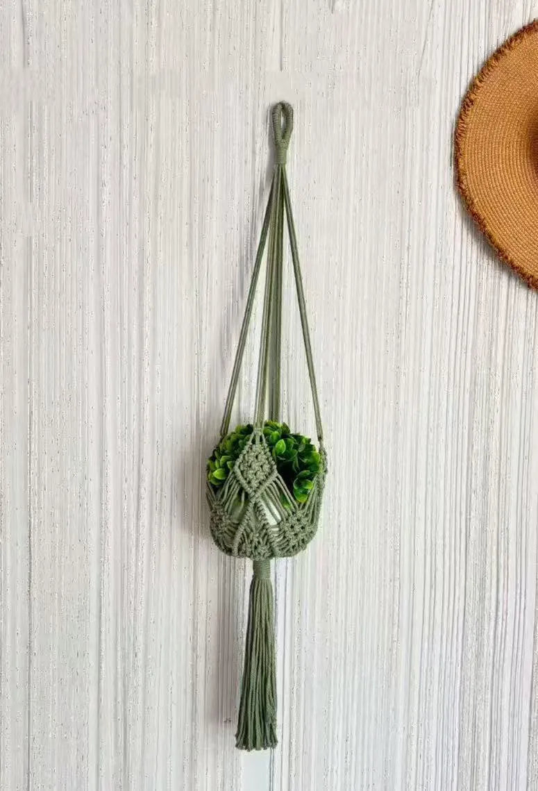 Hand-woven polyester cotton flower pot net pocket in brown, hanging with a green plant.