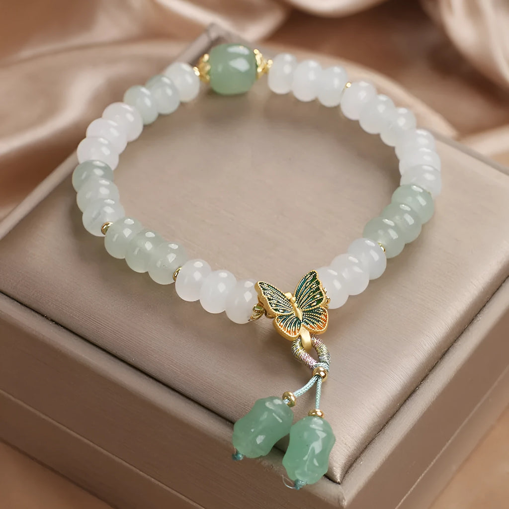 Green crystal abacus bead bracelet with retro butterfly tassel and pearl accents on a 17cm chain.