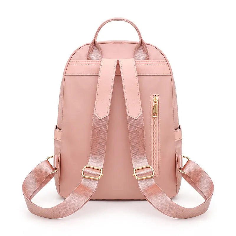 Women's black nylon casual backpack with double shoulder straps showing three-dimensional outer pockets