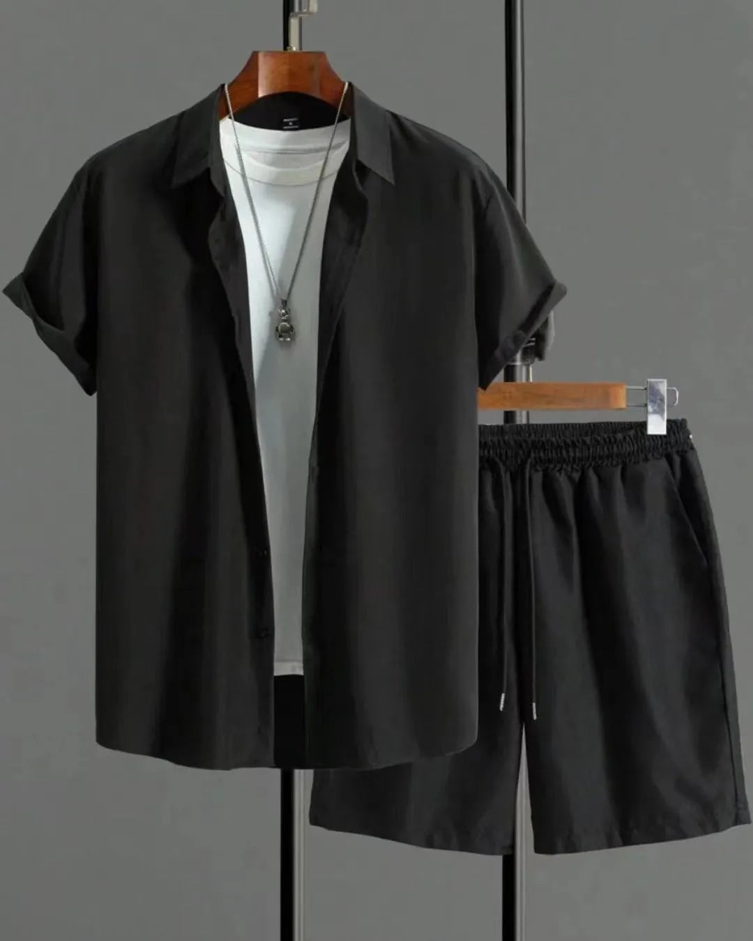 Man wearing black and white jacquard print short sleeve suit with shirt-style jacket and matching shorts
