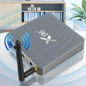 Android smart TV set-top box with voice remote control on a wooden table.