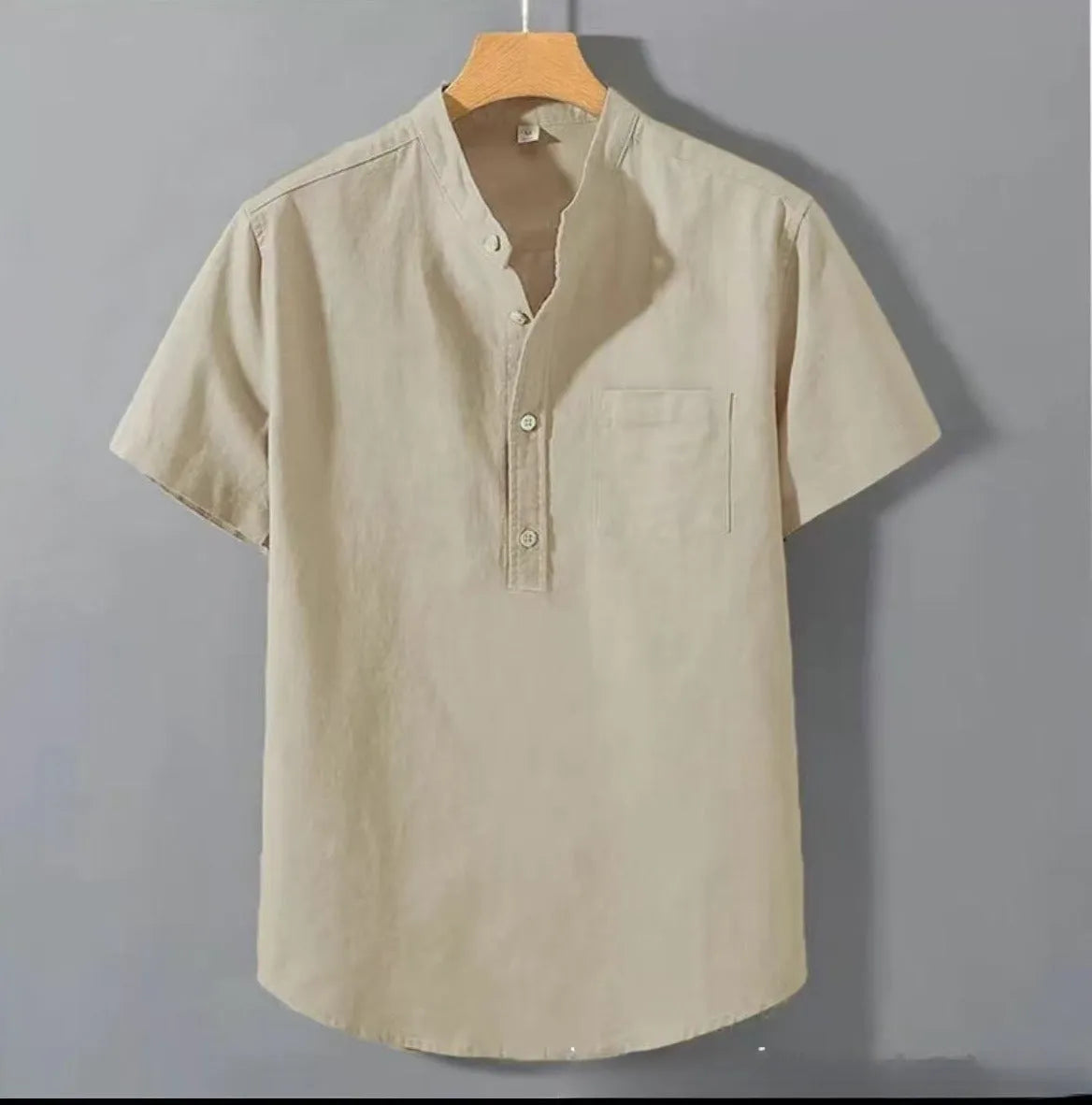 Men's casual beige linen short sleeve shirt with a stand collar and loose fit on a hanger.