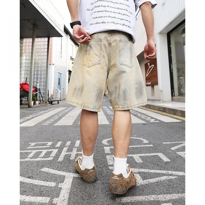 Men's light blue denim shorts with ripped detailing and a straight-leg cut.