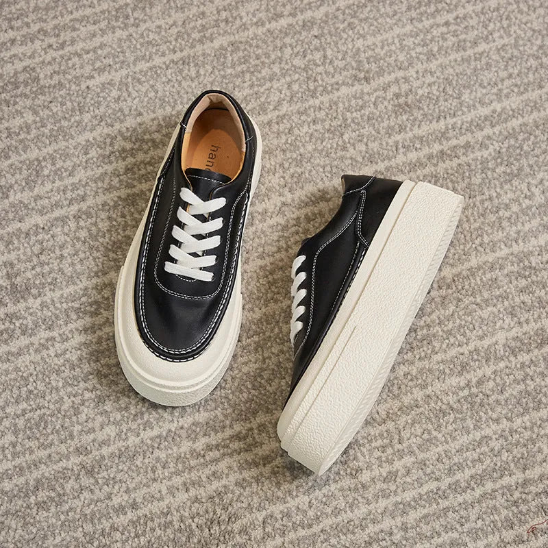 Women's black platform casual board shoes with embossed cowhide upper and round toe design