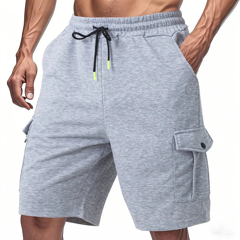 Man's light grey loose-fit cargo shorts made from heavy towel fabric with multiple pockets.