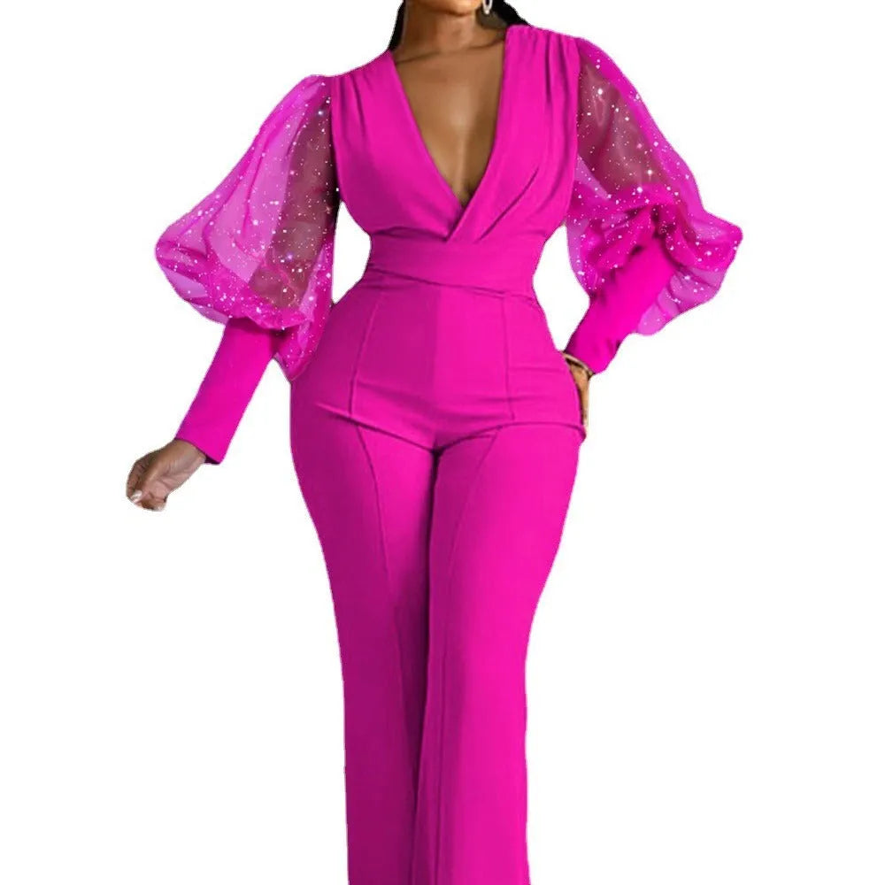 Red women's long sleeve jumpsuit with mesh stitching detail, elastic waist, and wide leg trousers.