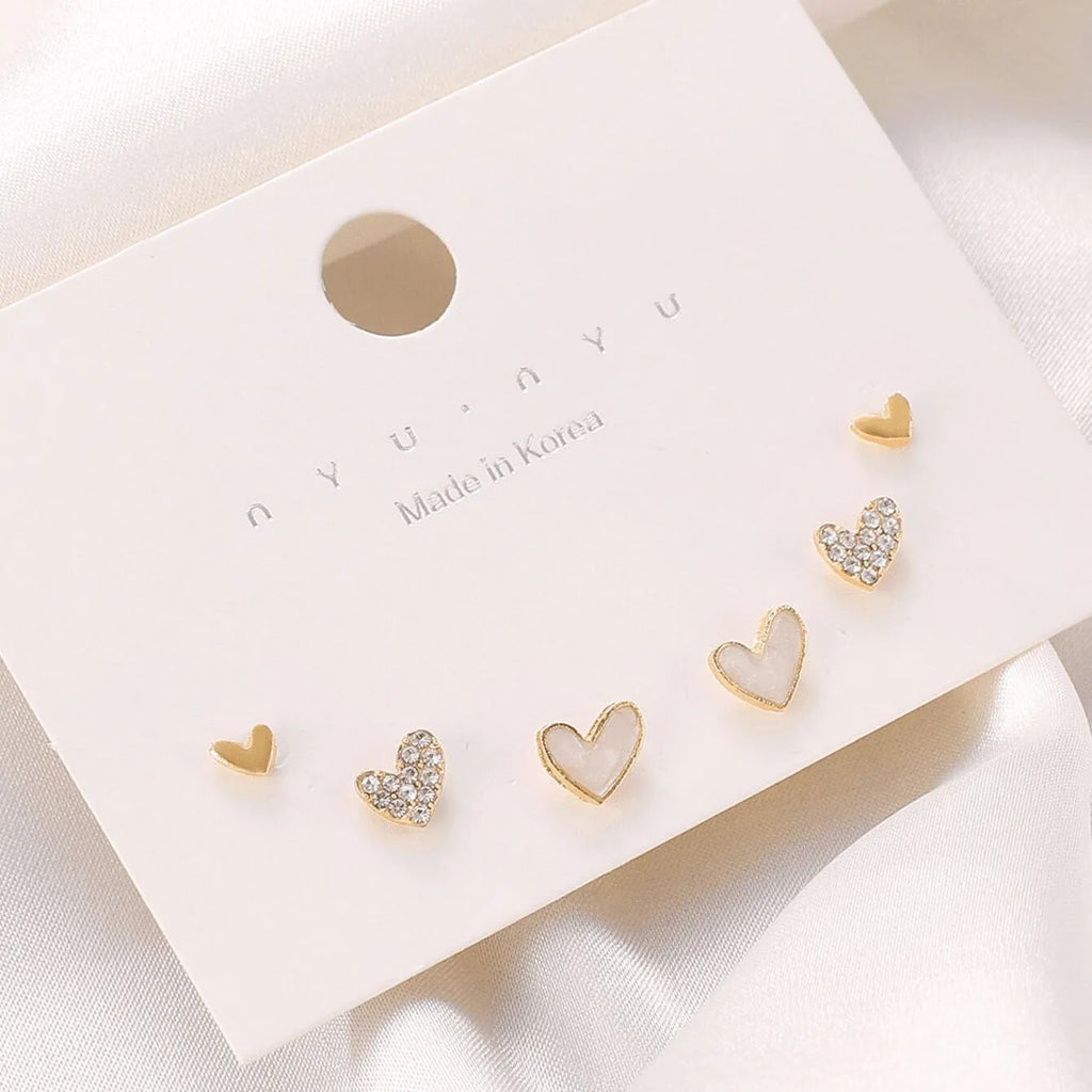 Three pairs of heart shape alloy earrings with electroplated gold, black, pink, and black-white colour options