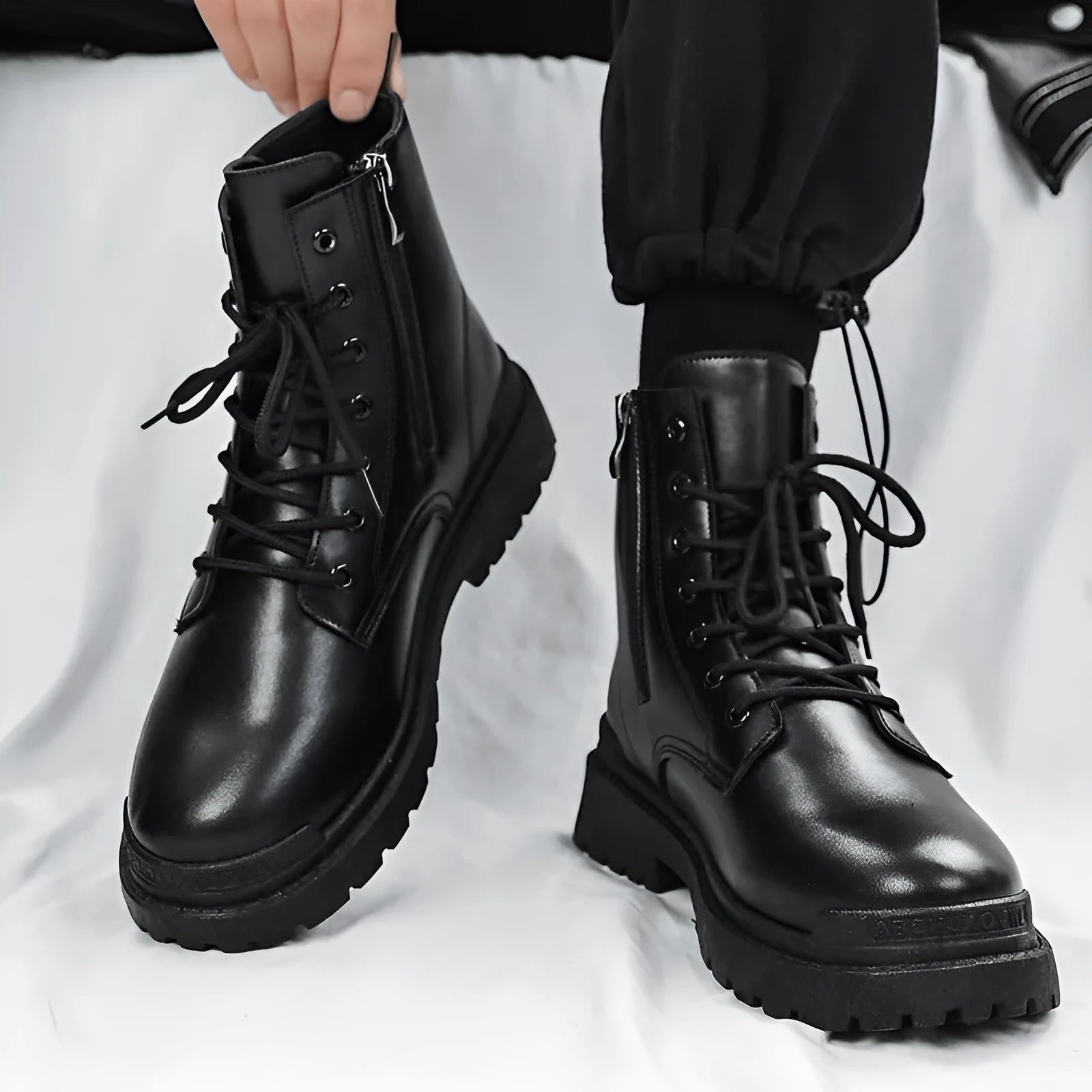 Men's black mid-top leather-style boots with rubber sole