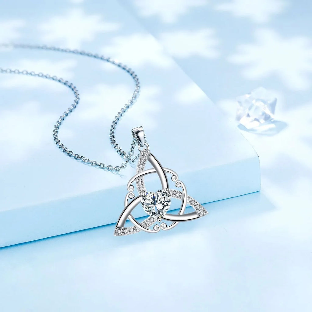 Close-up of a women's Celtic knot pendant necklace with geometric design in a choice of blue, lvzuan, red diamond or white diamond colour.