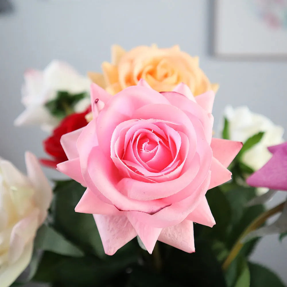 Artificial silk rose bouquet with red fabric flower head and green plastic stem