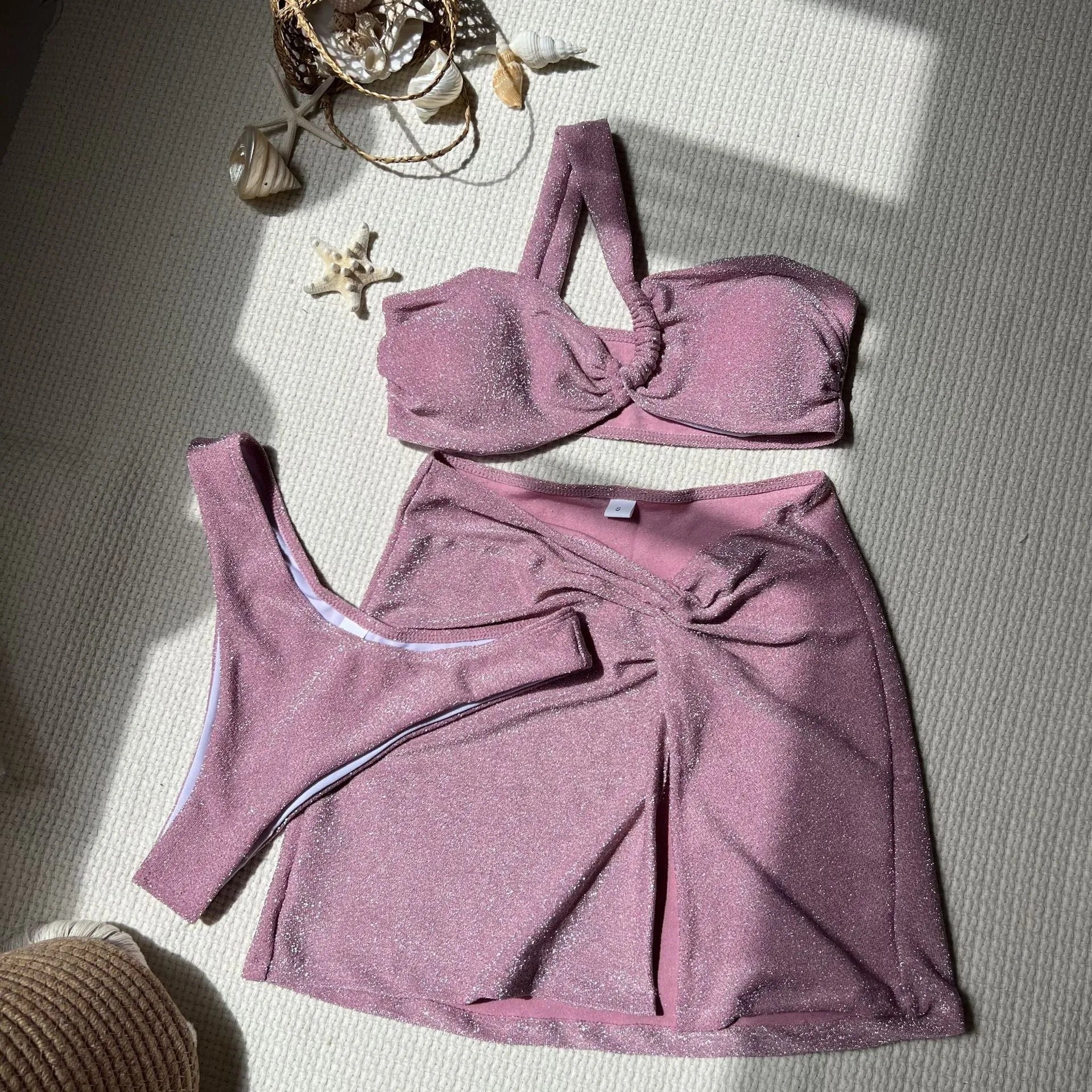 Three-piece one-shoulder swimsuit set in polyester with matching skirt
