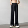 Black straight leg wide trousers on hanger showing loose fit and non-ironing fabric
