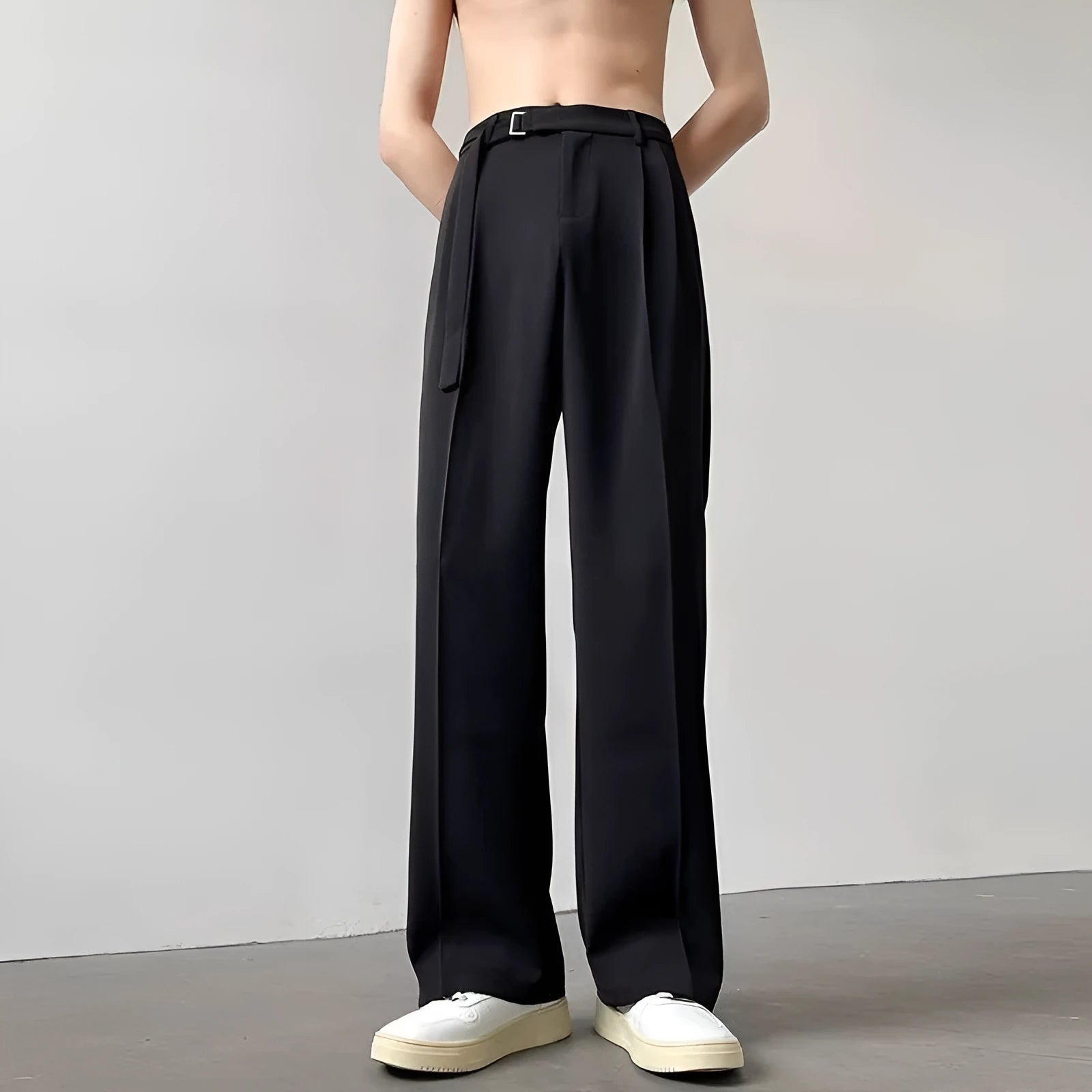 Black straight leg wide trousers on hanger showing loose fit and non-ironing fabric