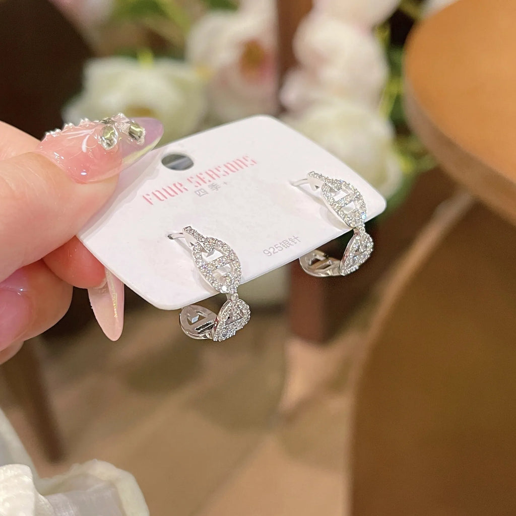 Ladies diamond-effect drop earrings in silver, gold, and rose gold electroplated finishes.