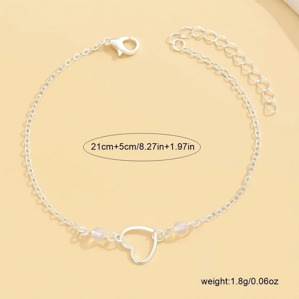 Gold and silver women's anklet with heart-shaped pendant charm and adjustable length