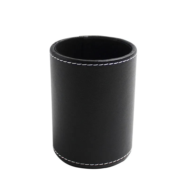 Round black leather pen holder on a desk