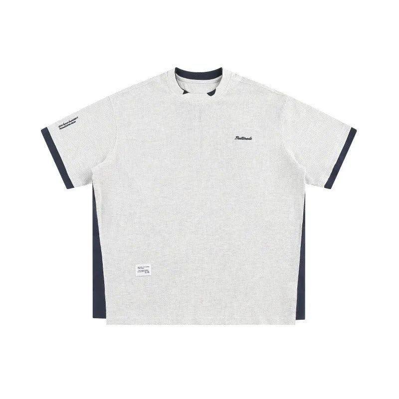 Loose-fit short-sleeved T-shirt with embroidered retro alphabet design on waffle-textured fabric.
