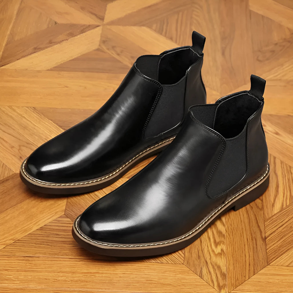 Black and brown formal pointed-toe leather boots with square heel and rubber sole.