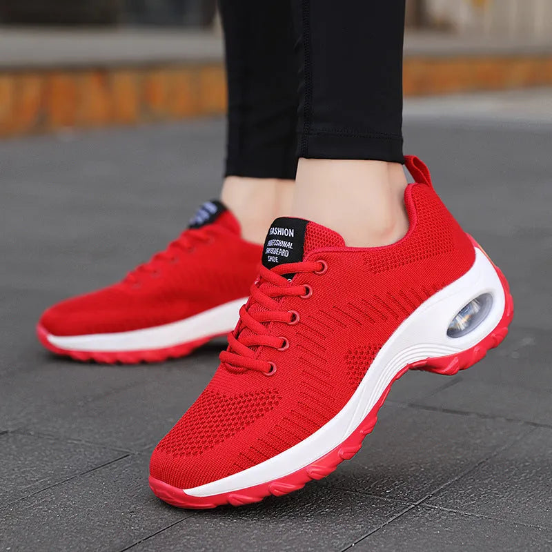 Women's red mesh sneakers with front lace-up design, round toe, and flat mid heel