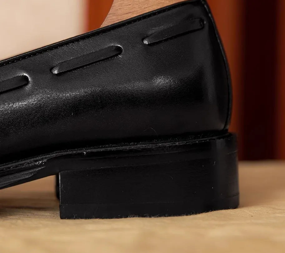 Men's black genuine leather slip-on loafers with a polished finish and rubber sole