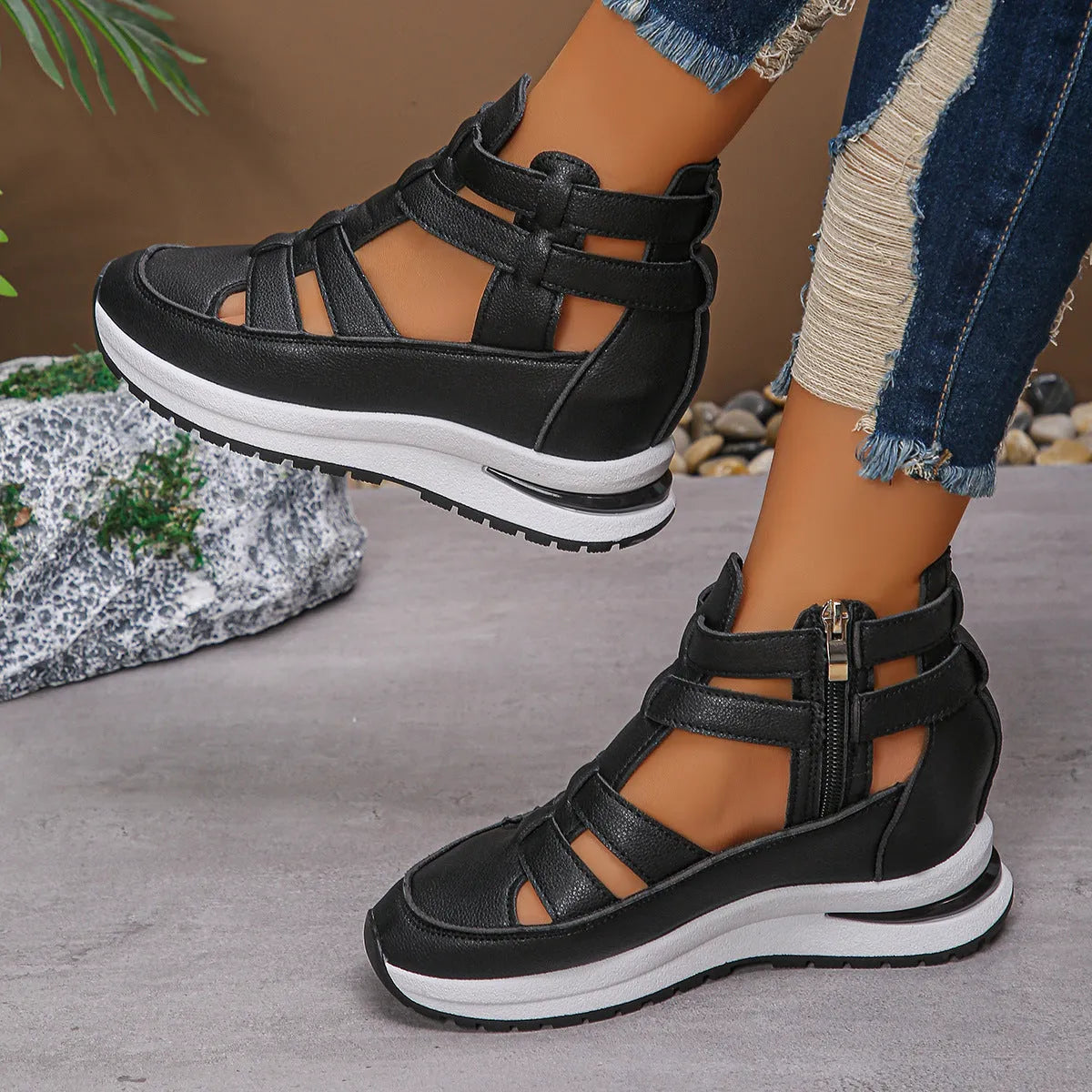 Women's black close-toed hollow-out platform sandals with a Velcro strap on a white background.