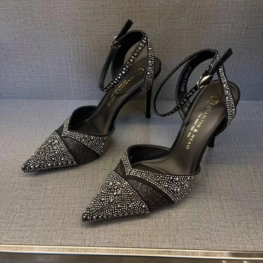 Women's silver hollow stiletto heels with pointed toe and red sole on white background