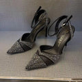 Women's silver hollow stiletto heels with pointed toe and red sole on white background