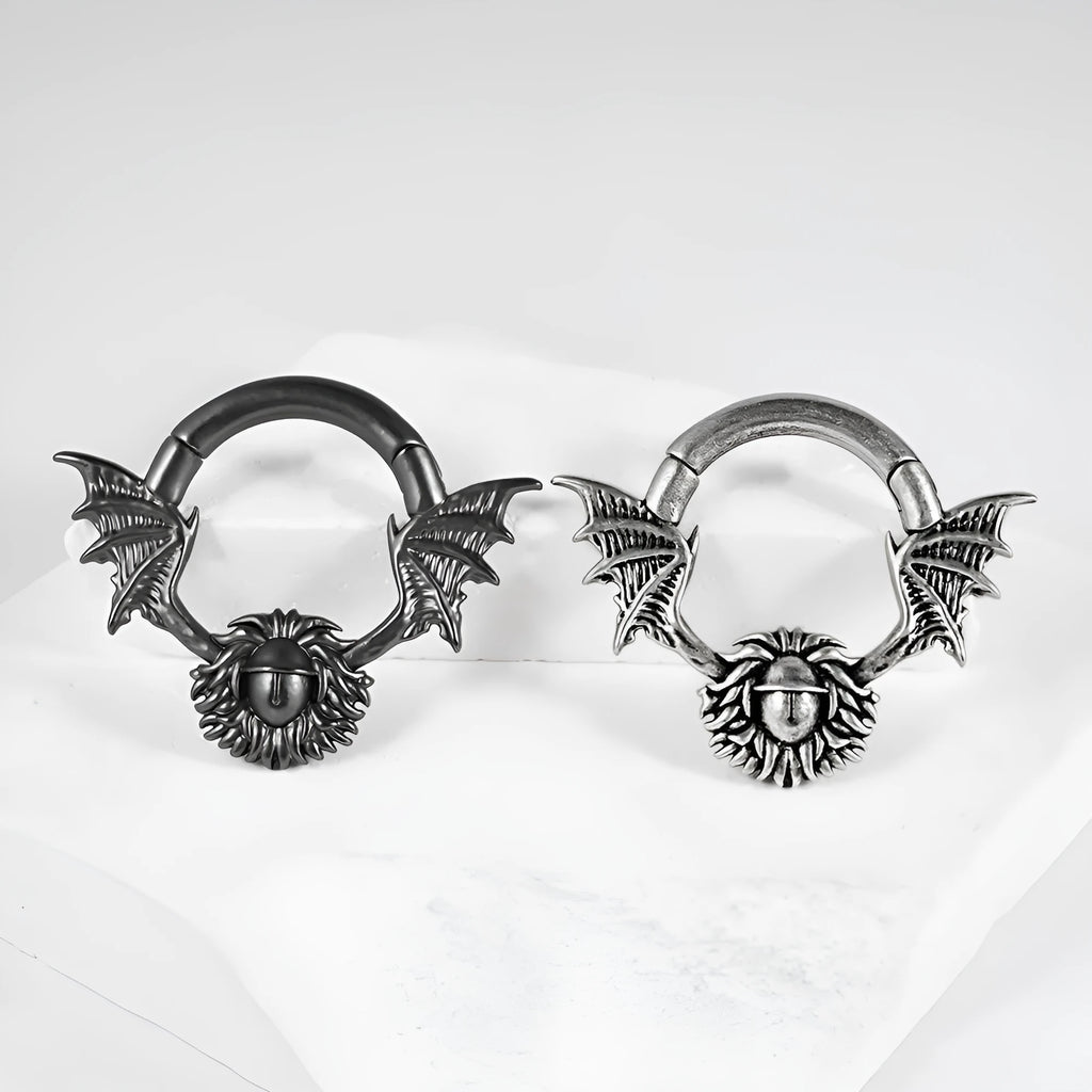 A pair of geometric sharp cone and round copper ear extenders with a magnetic closure in a silver finish.