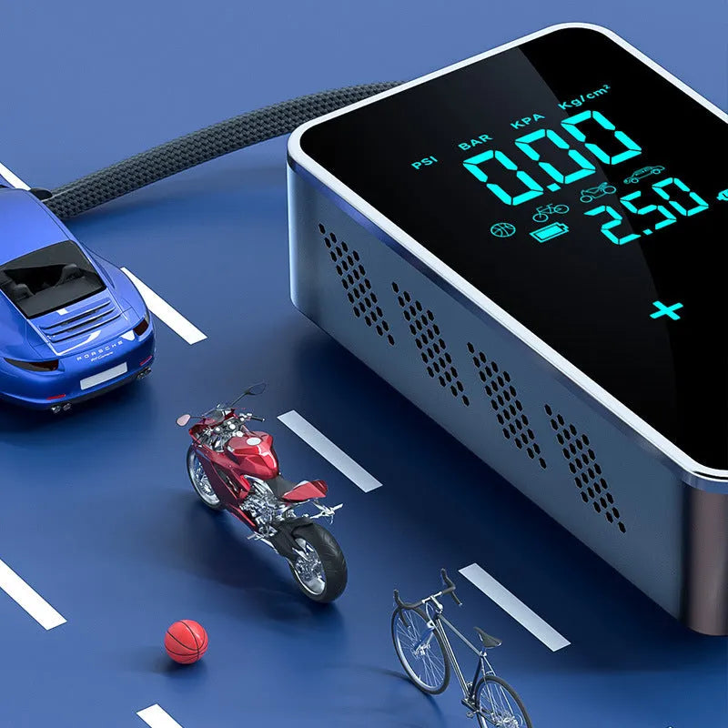 Compact black wireless car tyre inflator with LCD screen, air hose, and set of nozzles on a cloth bag.