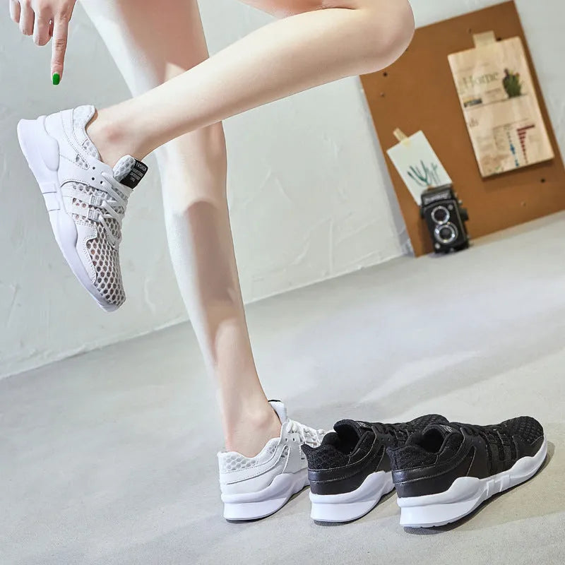 Low-top casual sneaker with mesh hollow-out upper and flat EVA sole in white.