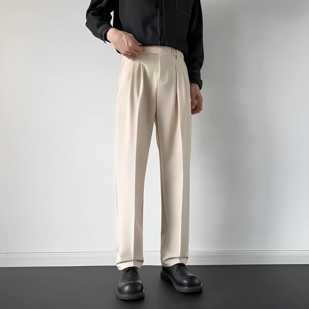 Men's straight-loose fit suit trousers in apricot colour hanging on a hanger.