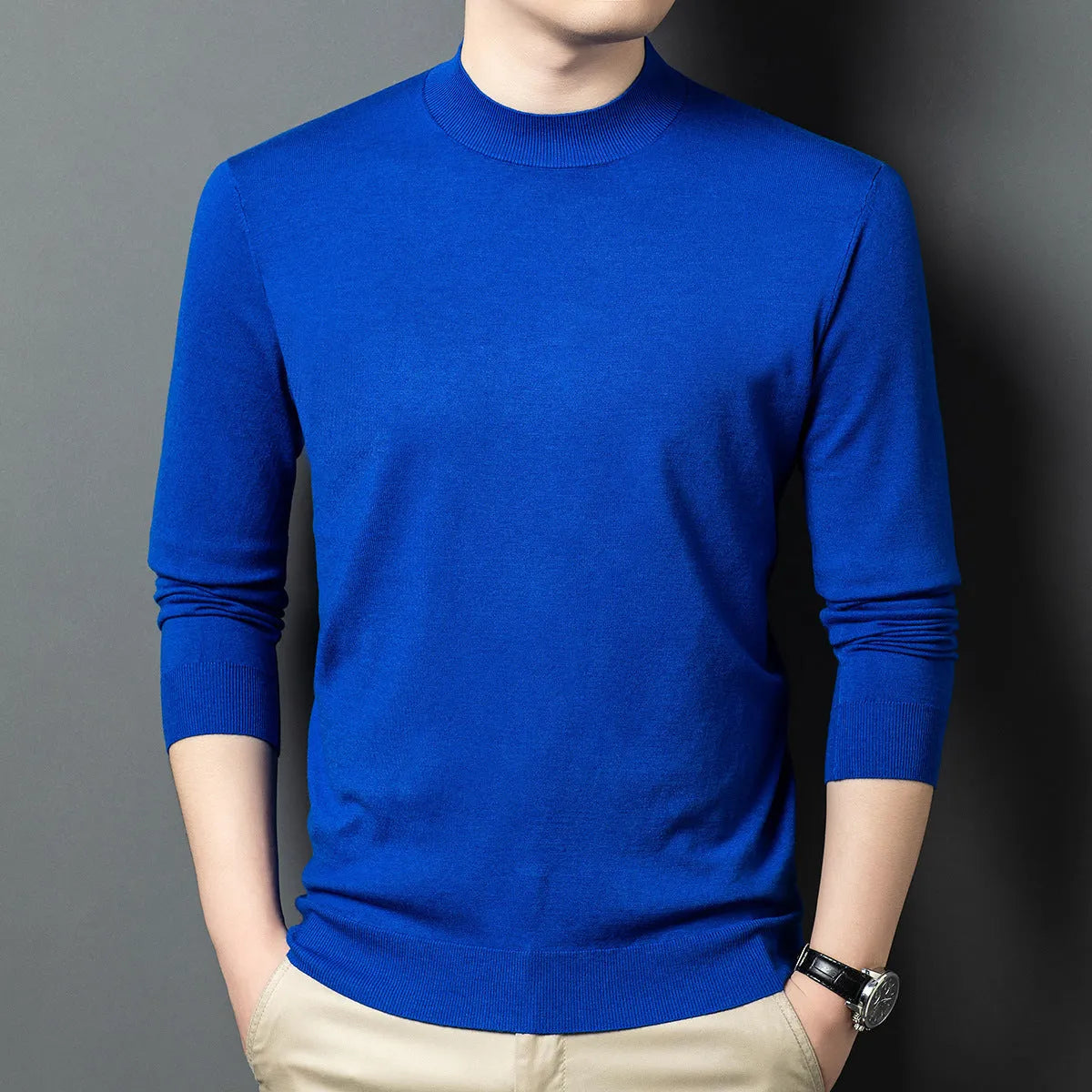Men's round neck wool pullover sweater in a neutral colour with long sleeves, laid flat.