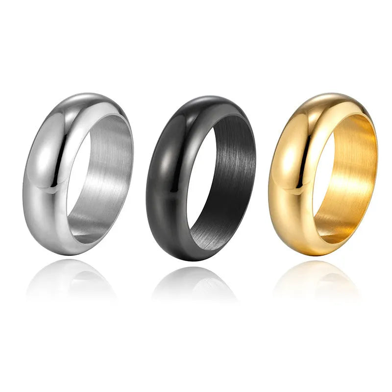Glossy electroplated titanium steel ring in gold colour on a grey background.