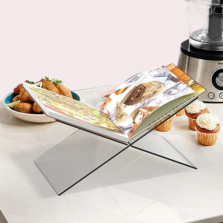 Clear acrylic X-shaped book display rack holding books upright on desktop