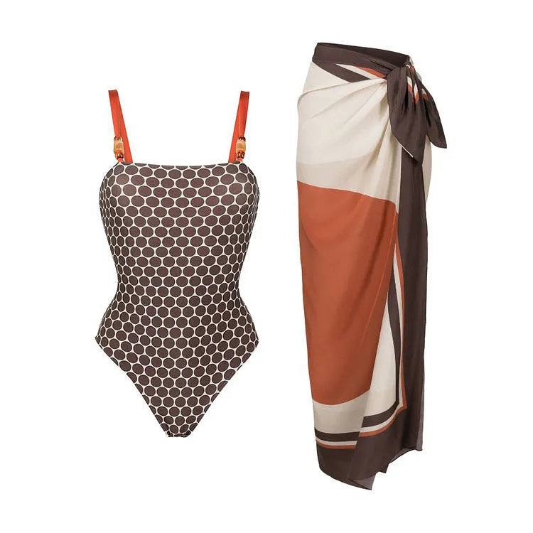 Women's printed dot pattern one-piece swimsuit with matching wrap skirt on a hanger.