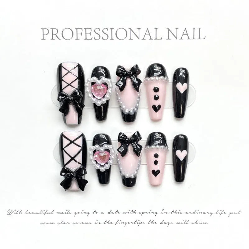 Black peach heart hand-painted detachable manicure set showing cat's eye design with bow patterns