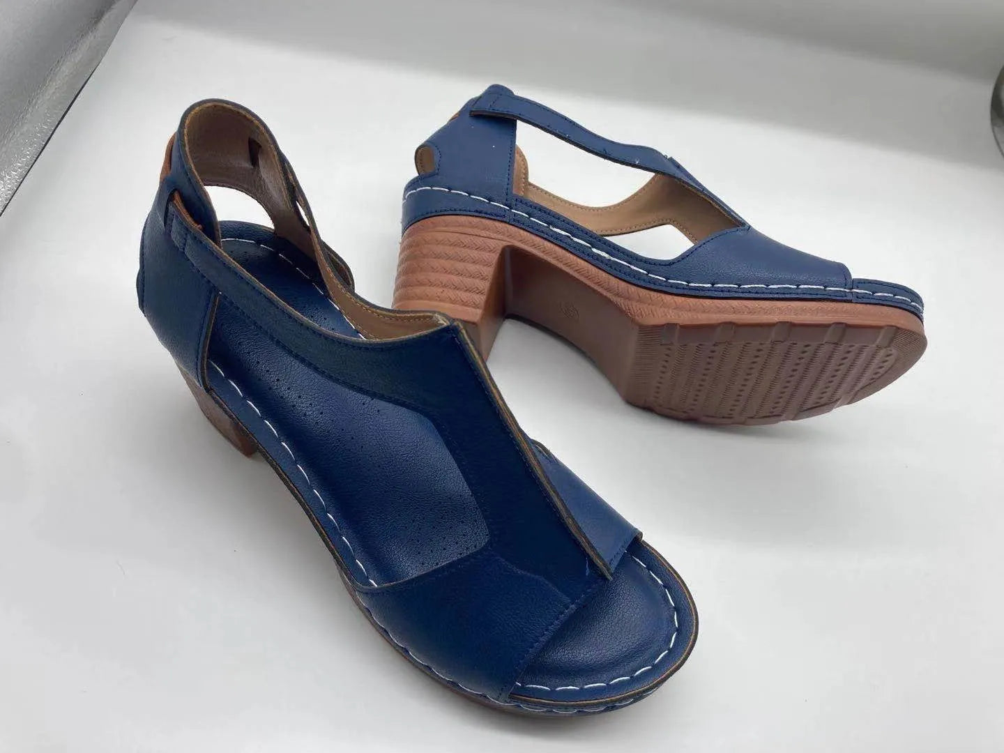 Women's peep toe wedge sandals with a buckle strap, shown in a light brown colour on a white background.