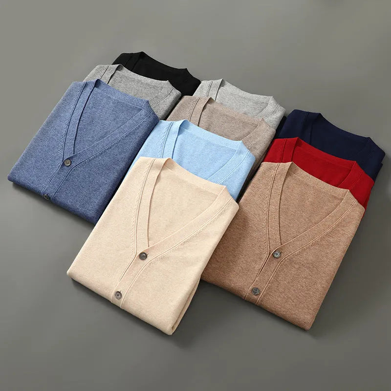 Man wearing a beige V-neck Andy velvet cardigan coat with a loose fit and long sleeves.