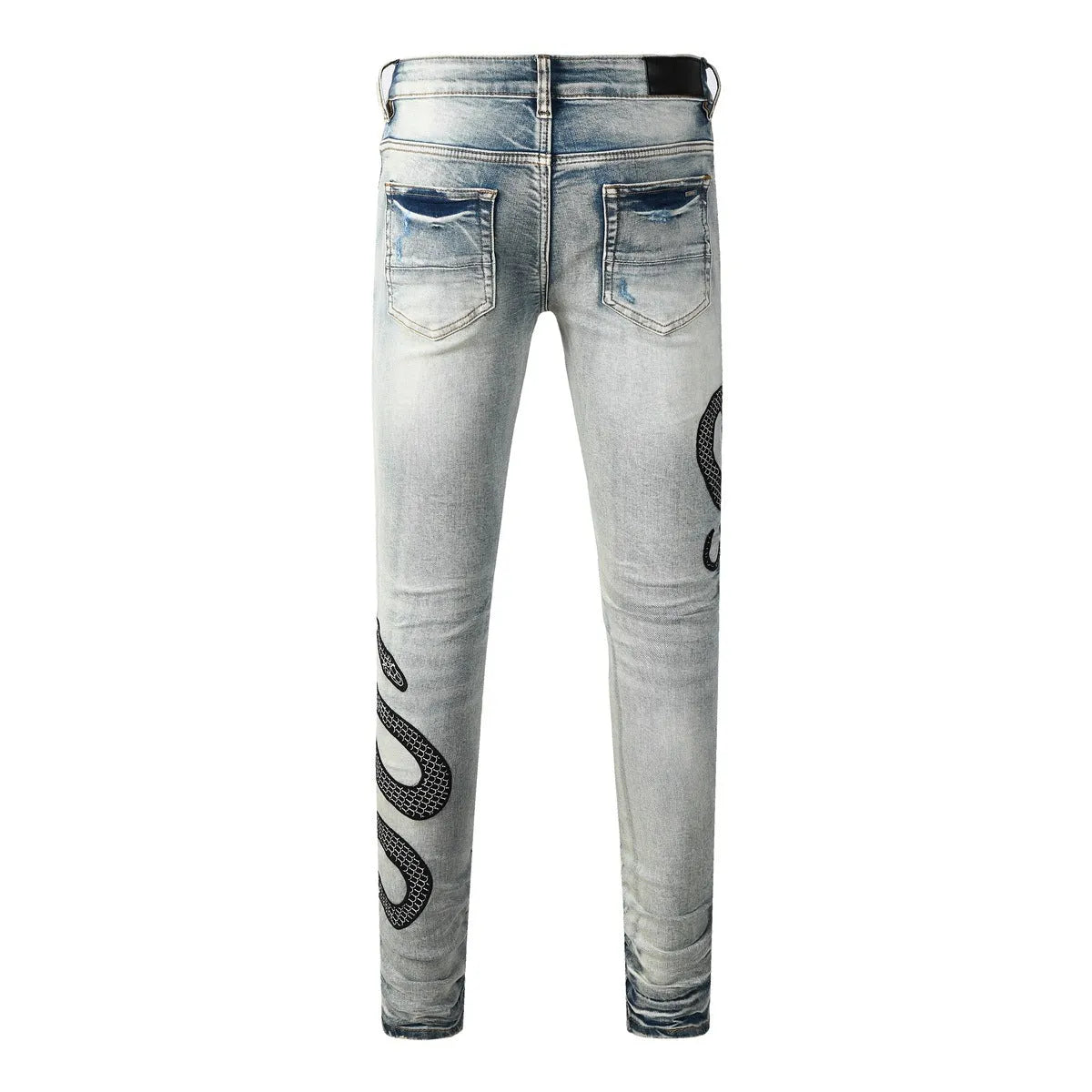 Man's blue distressed skinny jeans with a button fly and mid waist on a grey background.